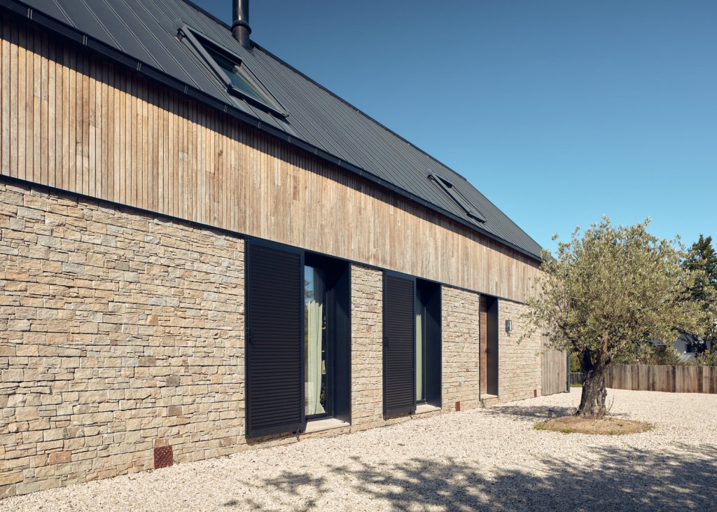 
Rural house, single-family house with stonepanel natural stone and wood façade.