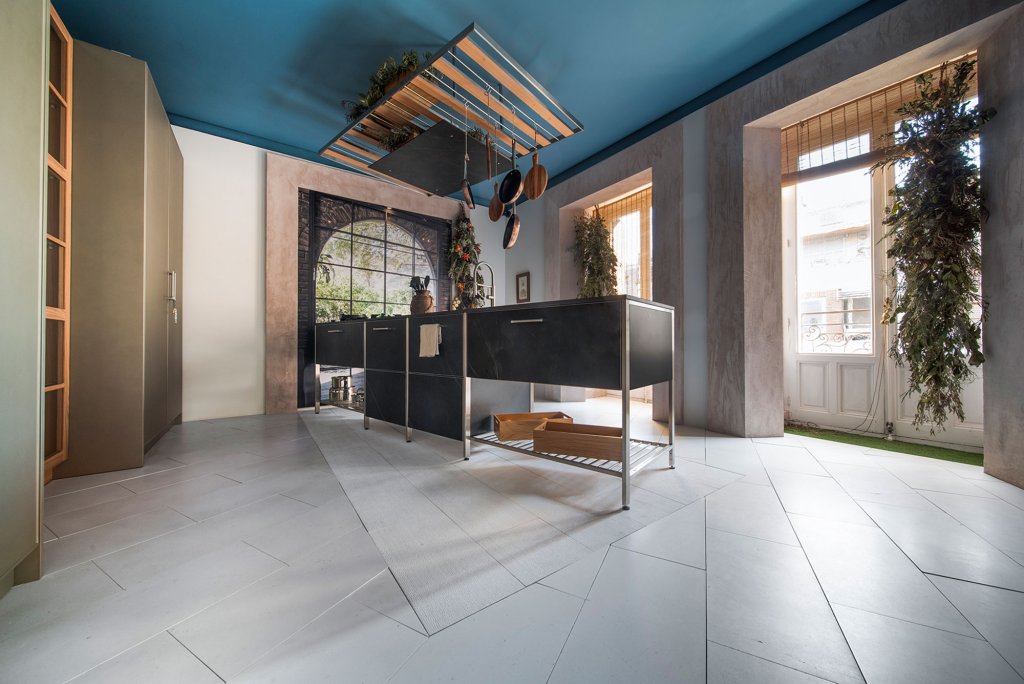 Limestone on the floor of this kitchen. Connect your spaces with biophilic design through natural stone.