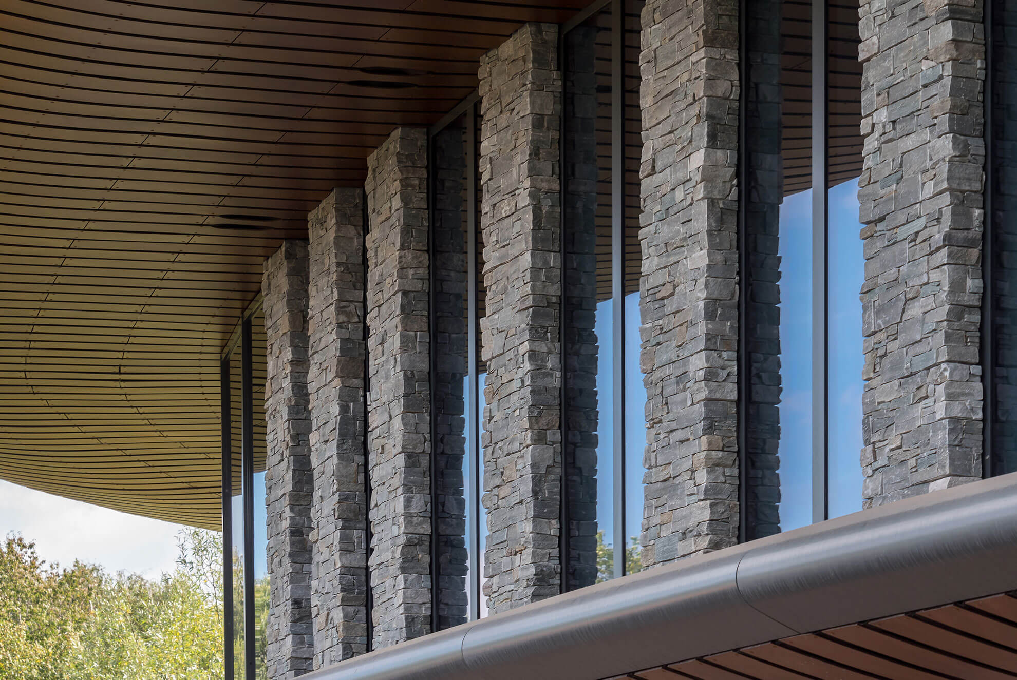 Modern architectural columns featuring STONEPANEL™ Nordic Dark, enhancing the façade with a sophisticated natural stone finish.