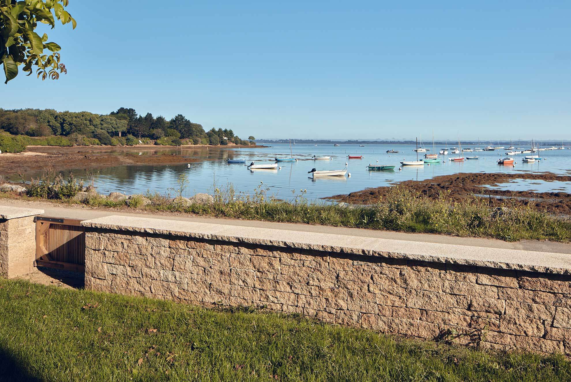 Garden wall featuring STONEPANEL™ Saint Yrieix natural stone, blending seamlessly with the coastal landscape.