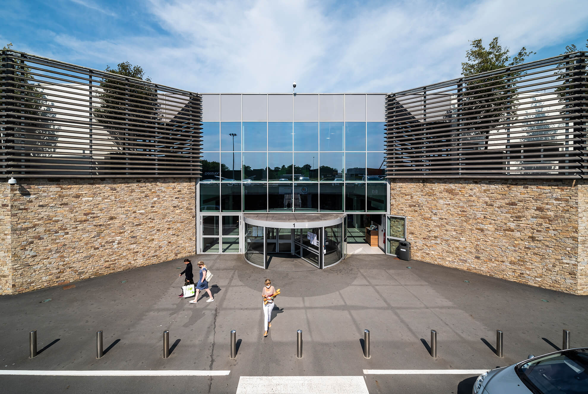 Commercial building featuring STONEPANEL™ Sylvestre natural stone cladding, creating a striking contrast with modern glass architecture.