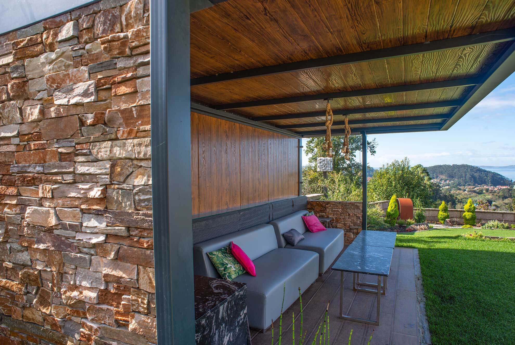 Outdoor terrace with STONEPANEL™ natural stone cladding, blending rustic charm with modern comfort.